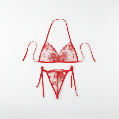 Red floral lace lingerie set arranged on a clean white background