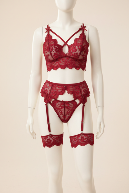 Deep red lace lingerie set with garter details displayed on a faceless mannequin
