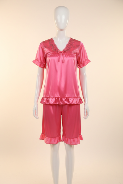 Bright pink satin short-sleeve pajama set displayed on a faceless mannequin