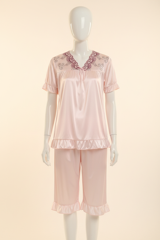 Pale pink satin short-sleeve pajama set displayed on a faceless mannequin